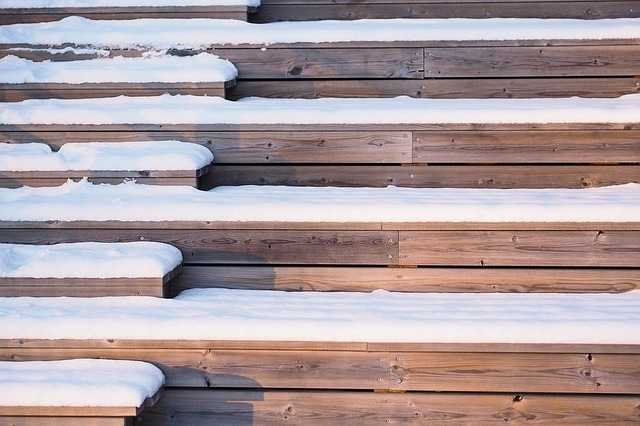 wooden steps covered in snow